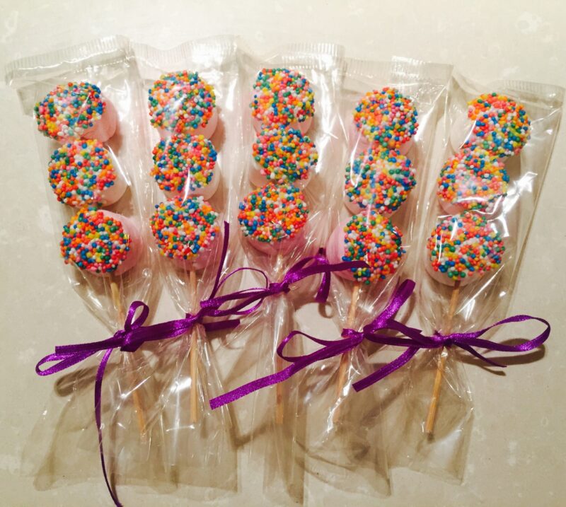 Japanese Omiyage 2 Colorful wrapped sweets on a stick wrapped in plastic and with a bow to be given as a jJpanese omiyage