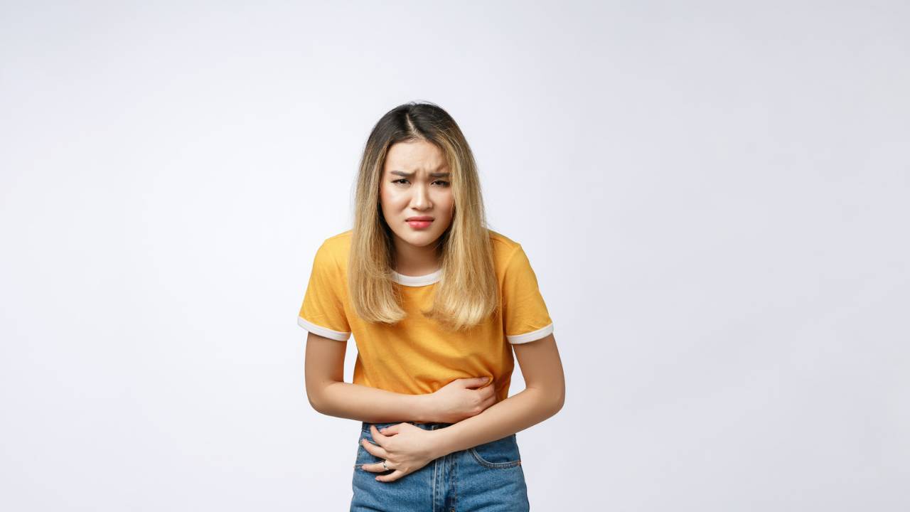 Batsu Game 4 Asian girl holding her stomach after eating something gross as part of a batsu game