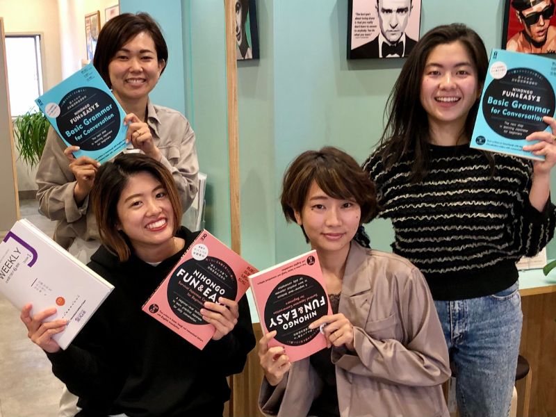 Shinjuku 3 Japanese language school staff holding Japanese textbooks