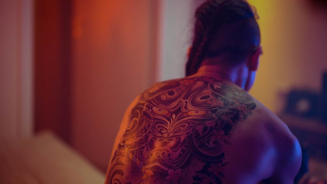 Tokyo Tattoo 7 Man with back tattoo and long hair