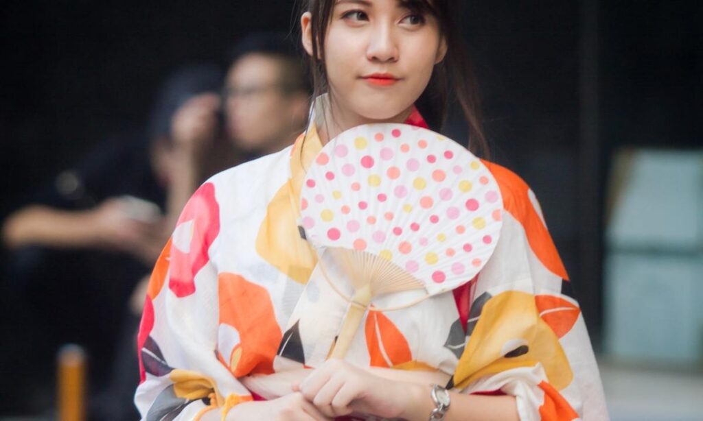 Japanese Fashion 2 Woman wearing a Japanese yukata and holding a fan