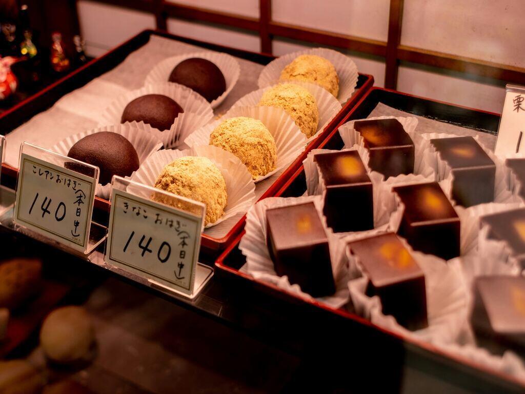 Showcase at a Japanese confectionery store. There are three types of sweets lining including yokan, red bean paste ohagi and roasted soybeans ohagi.