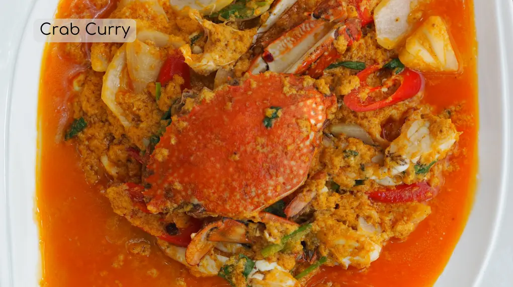 An image of a crab seafood curry in a white plate