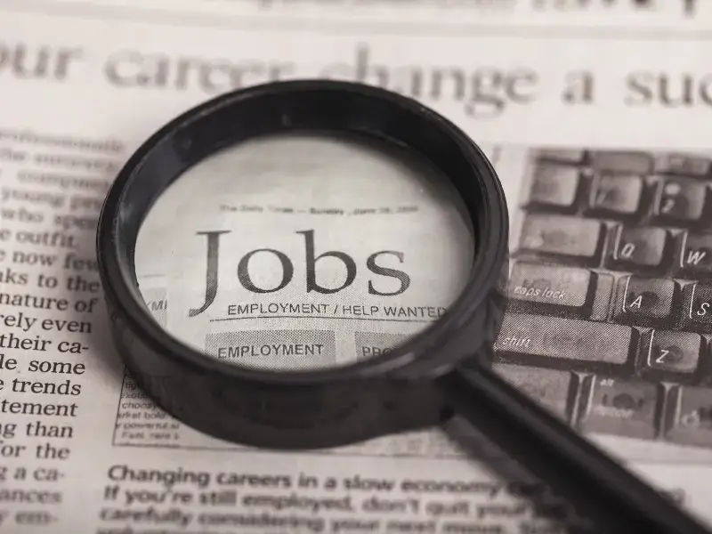 International student searching for a part-time job in Japan using newspaper job listings.