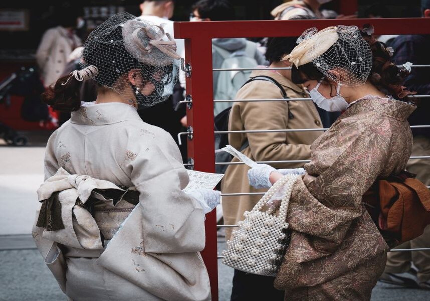 Shrines in Tokyo - Reading omikuji Japanese girls reading omikuji