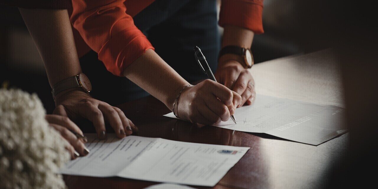 mandatory paperwork for getting married in Japan couple signing marriage paperwork in japan
